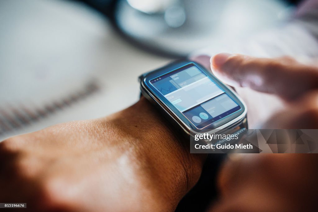 Businesswoman using smartwatch.