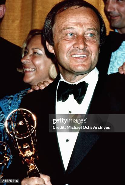 Sports commentator Jim McKay poses backstage with his trophy at the Emmy Awards in the 1970's in Los Angeles, California.