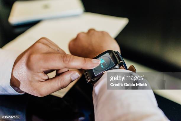 Finger touching smartwatch.