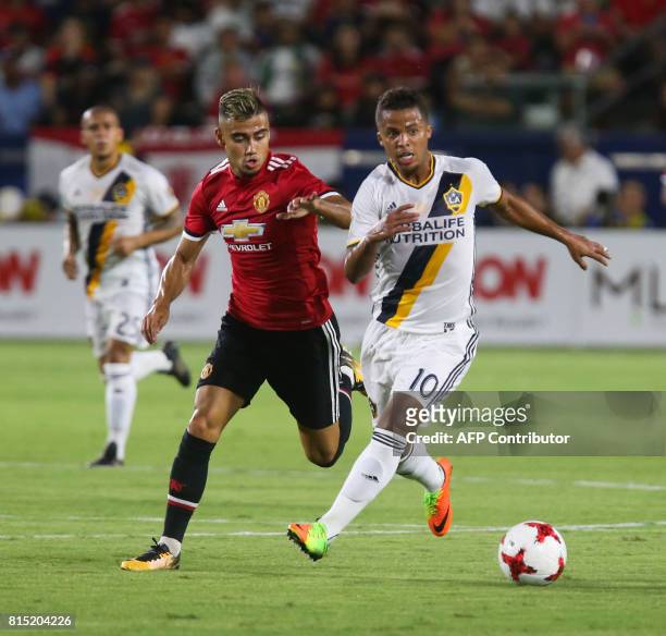 Manchester United Joel Pereira and Los Angeles Galaxy Giovani dos Santos battle for the ball during the second half of a national friendly soccer...