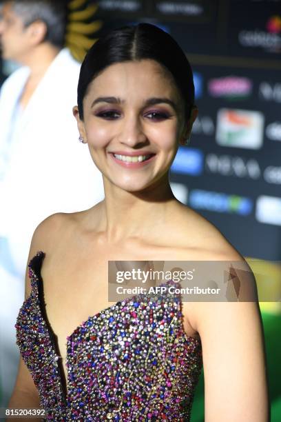 Bollywood actress Alia Bhat poses for the media and answers questions as she arrives for the IIFA Awards July 15, 2017 at the MetLife Stadium in East...