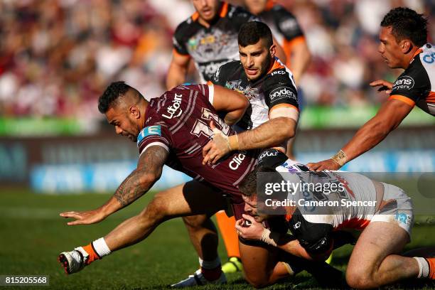 Frank Winterstein of the Sea Eagles is tackled during the round 19 NRL match between the Manly Sea Eagles and the Wests Tigers at Lottoland on July...