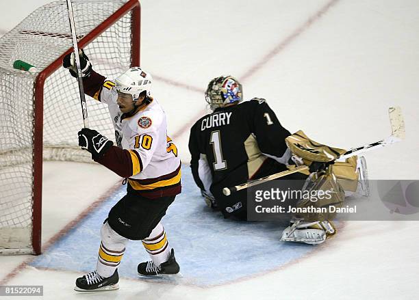 Jason Krog of the Chicago Wolves celebrates his third goal of the game as John Curry of the Wilkes-Barre/Scranton Penguins looks for the puck during...