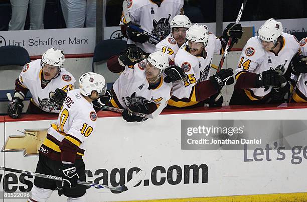 Jason Krog of the Chicago Wolves is congratulated by teammates on the bench after scoring a hat trick against the Wilkes-Barre/Scranton Penguins...