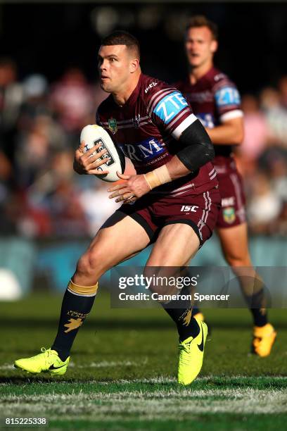 Darcy Tussock of the Sea Eagles runs the ball during the round 19 NRL match between the Manly Sea Eagles and the Wests Tigers at Lottoland on July...