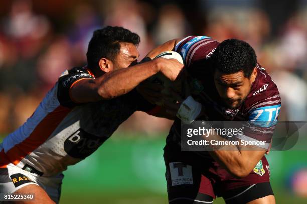 Matthew Wright of the Sea Eagles is tackled during the round 19 NRL match between the Manly Sea Eagles and the Wests Tigers at Lottoland on July 16,...