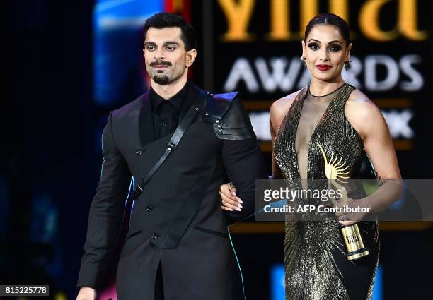 Bollywood actress Bipasha Basu and her husand Karan Singh Grover arrive on stage during the 18th International Indian Film Academy Festival at the...