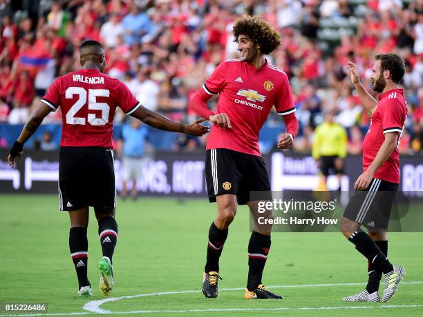 Marouane Fellaini of Manchester United celebrates his goal with Luis Antonio Valencia and Juan Mata to take a 3-0 lead over the Los Angeles Galaxy...