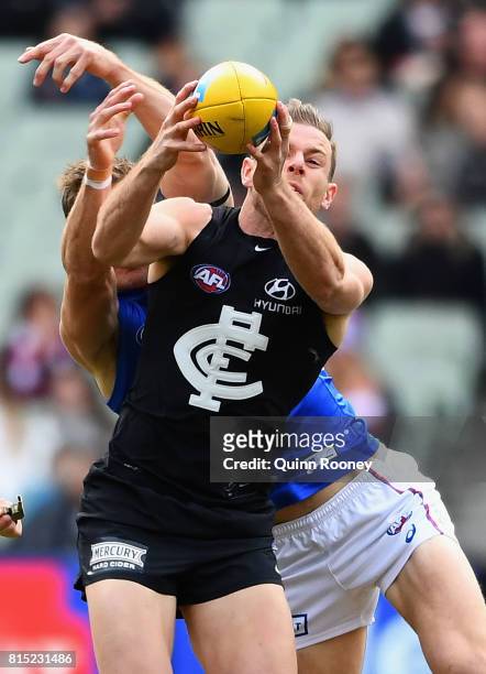 Sam Docherty of the Blues marks infront of Dale Morris of the Bulldogs during the round 17 AFL match between the Carlton Blues and the Western...