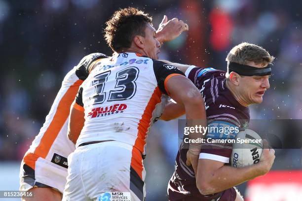 Thomas Trbojevic of the Sea Eagles is tackled during the round 19 NRL match between the Manly Sea Eagles and the Wests Tigers at Lottoland on July...