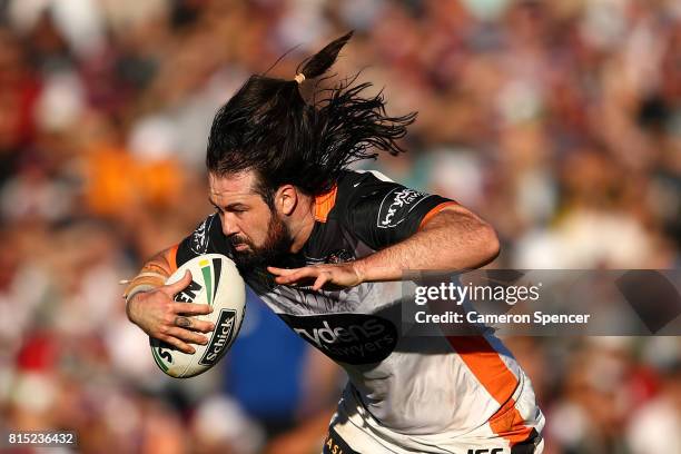 Aaron Woods of the Tigers runs the ball during the round 19 NRL match between the Manly Sea Eagles and the Wests Tigers at Lottoland on July 16, 2017...