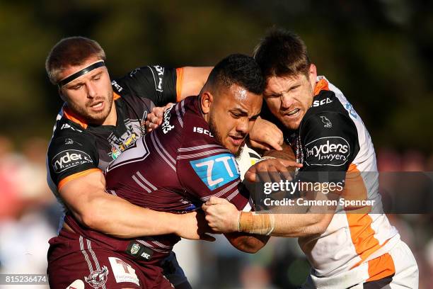 Adding Fonua-Blake of the Sea Eagles is tackled during the round 19 NRL match between the Manly Sea Eagles and the Wests Tigers at Lottoland on July...