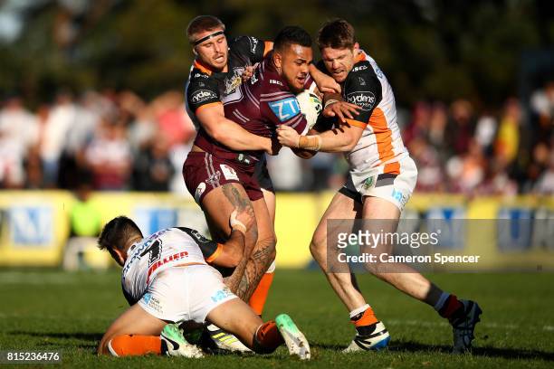 Adding Fonua-Blake of the Sea Eagles is tackled during the round 19 NRL match between the Manly Sea Eagles and the Wests Tigers at Lottoland on July...