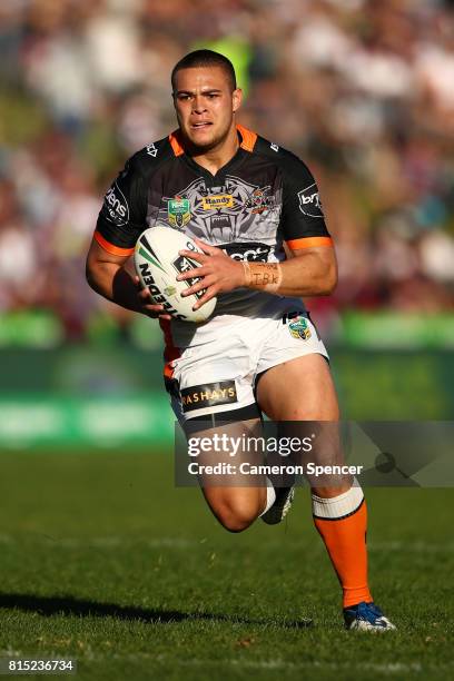 Tuimoala Lolohea of the Tigers runs the ball during the round 19 NRL match between the Manly Sea Eagles and the Wests Tigers at Lottoland on July 16,...