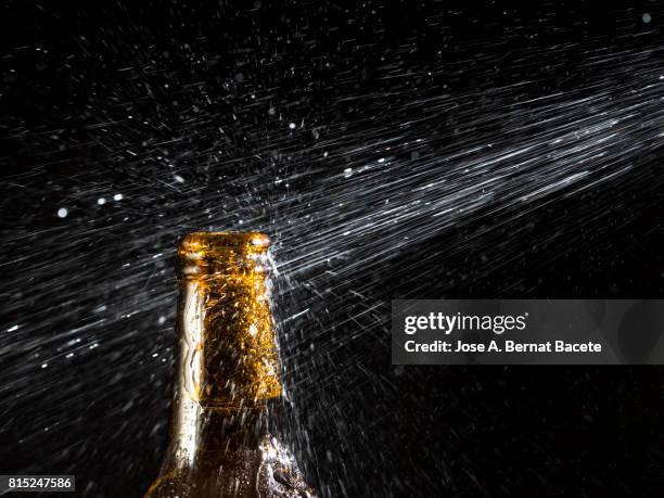 bottle of beer with the glass esmerilado with drops of water and a steam cloud frozen on a black bottom - beer mat stockfoto's en -beelden