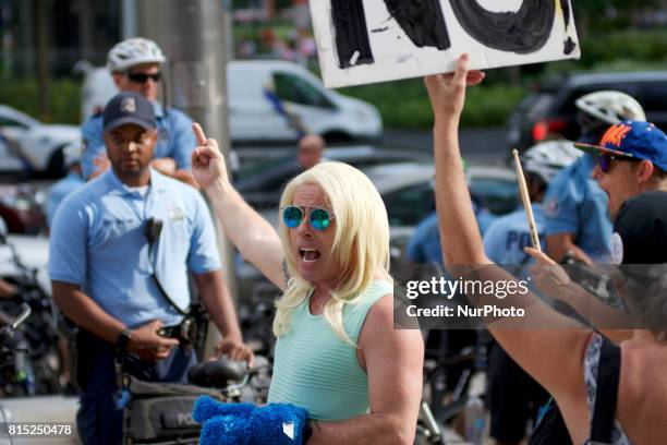 Michael Hisey, dressed up as Kellyanne Conway, takes part in an anti-Trump Refuse Racism rally in Philadelphia, Pennsylvania, on July 15, 2017.