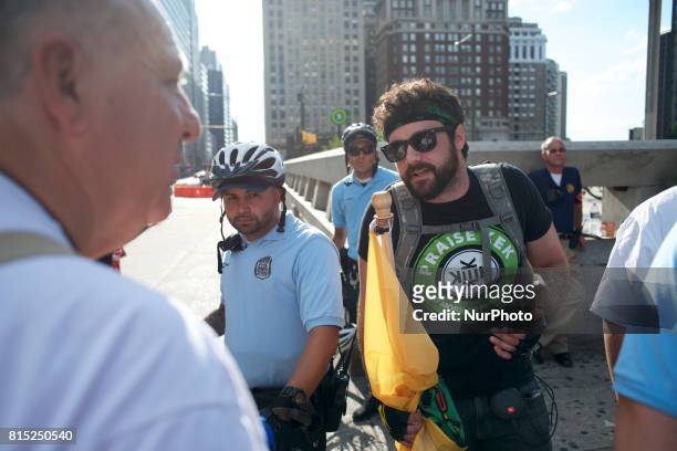 Trump supporters in a Kekistani shirt referring to a fictional country based on a meme is seen discussing with a protestor on the sidelines of a...