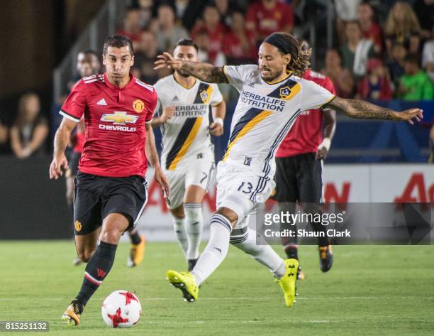 Henrikh Mkhitaryan of Manchester United goes past Jermaine Jones of Los Angeles Galaxy during the Los Angeles Galaxy's friendly match against...