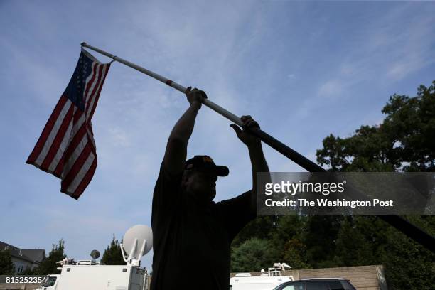 Pro gun owner hols a flag in front of the National Rifle Association headquarters in Fairfax, Va., during a rally organized by Womens March to...