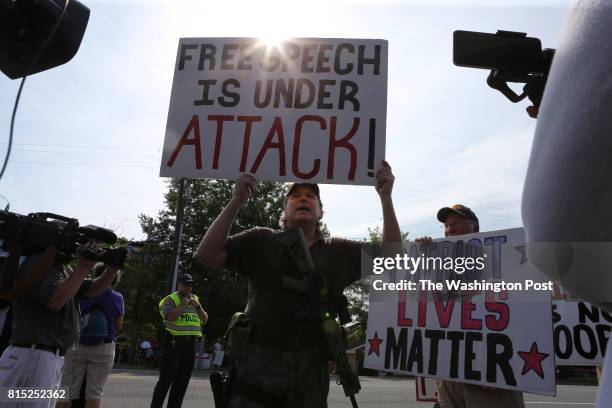 Jeff, a pro gun supporter from Annapolis, MD., marches past a group of gun control supporters in front of the National Rifle Association headquarters...
