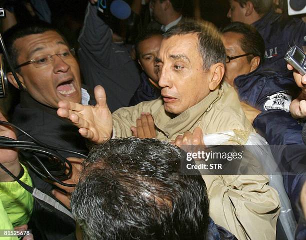 Former governor of Mexican Quintana Roo state, Mario Villanueva Madrid , is surrouinded by members of the Mexican Federal Police on July 21, 2007 at...