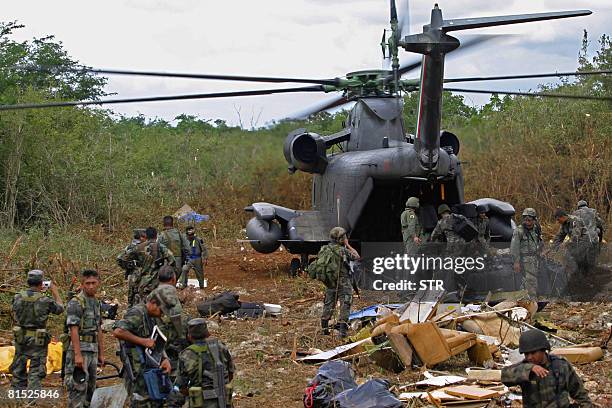 Mexican soldiers guard the 3.3-ton seizure of pure cocaine, after the crash of the "Golf Stream II" airplane from Colombia, at the Merida jungle in...