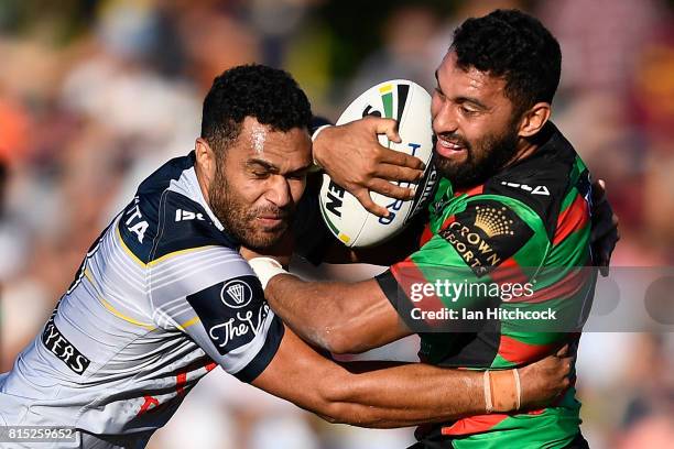 Alex Johnston of the Rabbitohs is tackled by Justin O'Neil of the Cowboys during the round 19 NRL match between the South Sydney Rabbitohs and the...