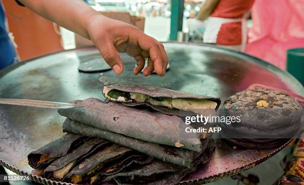 https://media.gettyimages.com/id/81526726/photo/a-mexican-woman-prepares-quesadillas-and-gorditas-on-a-comal-at-a-street-stand-in-mexico-city.jpg?s=612x612&w=gi&k=20&c=uNHTHnk6b8yttBtRmQ5oqZsataINV25Ljip1xCplbME=