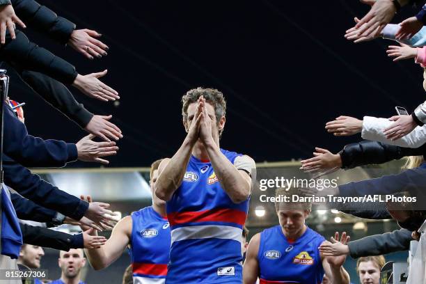 Robert Murphy of the Bulldogs leads his team off the ground after the round 17 AFL match between the Carlton Blues and the Western Bulldogs at...