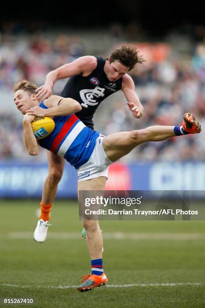 Lachie Hunter of the Bulldogs marks the ball in front of Jed Lamb of the Blues during the round 17 AFL match between the Carlton Blues and the...