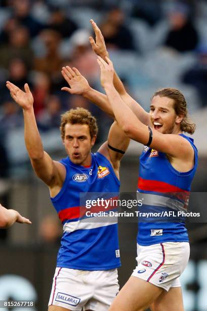 Mitch Wallis and Marcus Bontempelli of the Bulldogs celebrate a goal during the round 17 AFL match between the Carlton Blues and the Western Bulldogs...