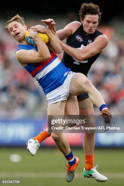 Lachie Hunter of the Bulldogs marks the ball in front of Jed Lamb of the Blues during the round 17 AFL match between the Carlton Blues and the...