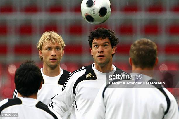 Michael Ballack of Germany challenge for the ball during the training session of the German national team at the Woerthersee Stadium on June 11, 2008...