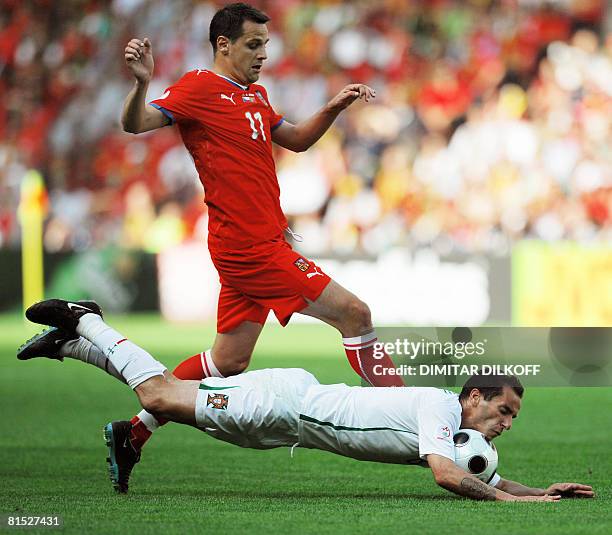 Portuguese midfielder Petit falls to the ground as he vies for the ball with Czech midfielder Stanislav Vlcek during the Euro 2008 Championships...