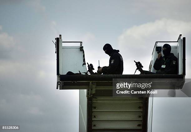 Snipers of the german federal police sit in a gangway before U.S. President George W. Bush arrives in a helicopter to his departure at Tegel Airport...