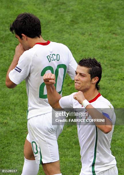 Portuguese forward Cristiano Ronaldo gestures in celebration as Portuguese midfielder Deco walks by after their Euro 2008 Championships Group A...