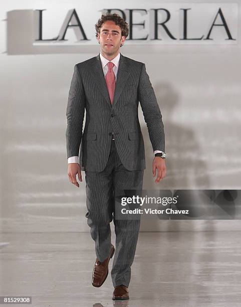 Actor Carlos De La Mota walks down the catwalk wearing "La Perla" Frattina Collection during a benefit runway for Bajando Una Estrella foundation at...