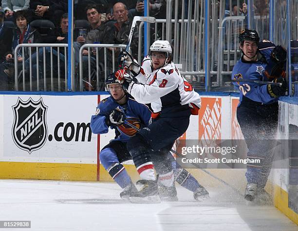 Alexander Ovechkin of the Washington Capitals battles for the puck against Tobias Enstrom of the Atlanta Thrashers at Philips Arena on February 13,...