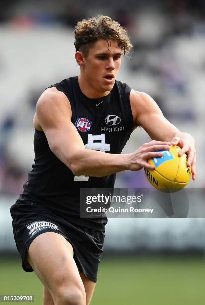 Charlie Curnow of the Blues kicks during the round 17 AFL match between the Carlton Blues and the Western Bulldogs at Melbourne Cricket Ground on...