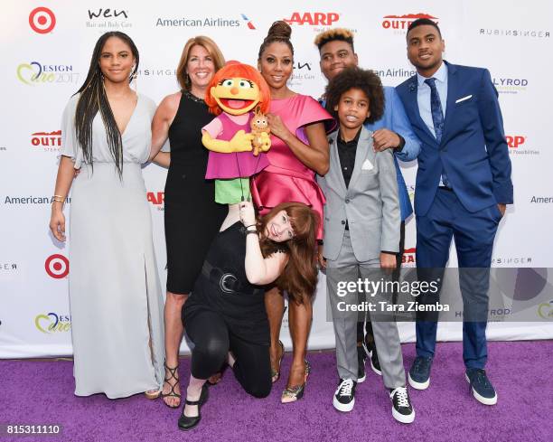 Ryan Elizabeth Peete, Host Holly Robinson Peete, Roman Peete, Rodney Peete Jr, Robinson James Peete pose with the first autistic Sesame Street...