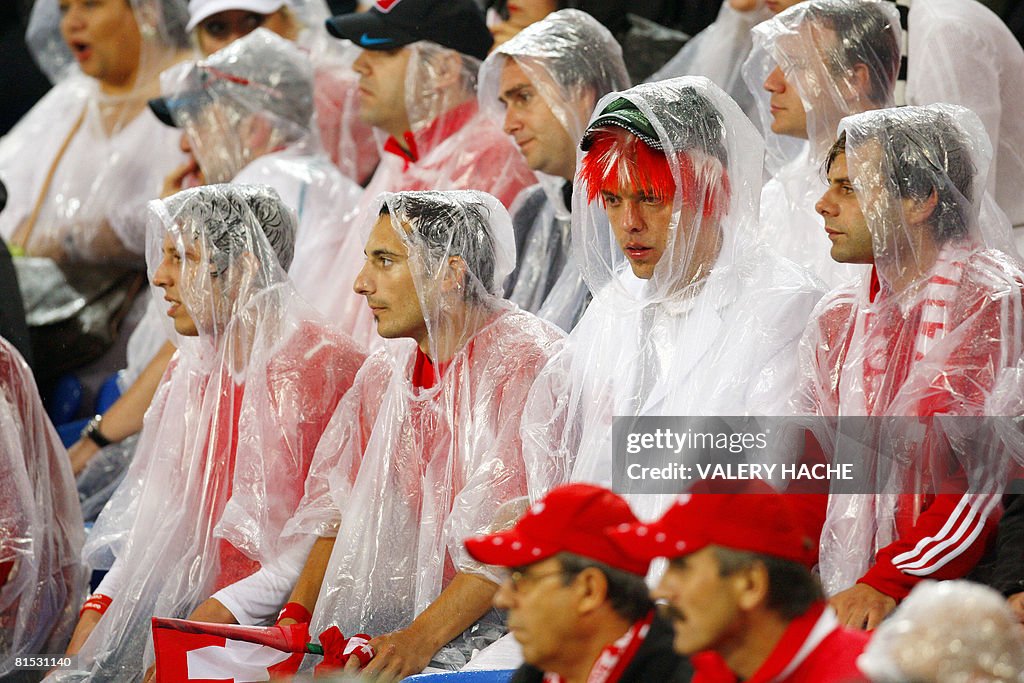 Supporters protect themselves from heavy