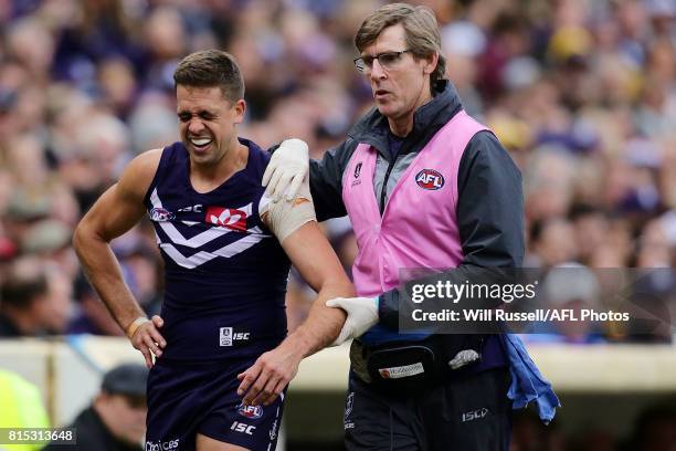 Stephen Hill of the Dockers leaves the field injured with a dislocated shouder during the round 17 AFL match between the Fremantle Dockers and the...