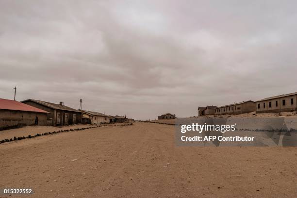 Picture taken on June 27, 2017 shows abandoned houses covered with sand, in the deserted mining town of Kolmanskop, in Luderitz, Namibia. The...