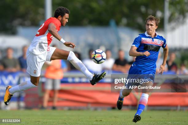 Monaco's Spanish forward Jordi Mboula vies for the ball with Stoke City's Spanish defender Marc Muniesa during a friendly football match between AS...