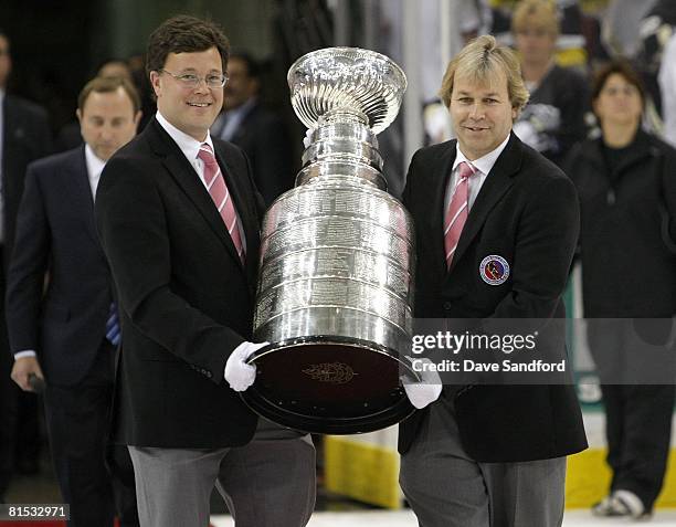 Curators from the Hockey Hall of Fame, Craig Campbell and Phil Pritchard carry the Stanley Cup onto the ice after game six of the 2008 NHL Stanley...