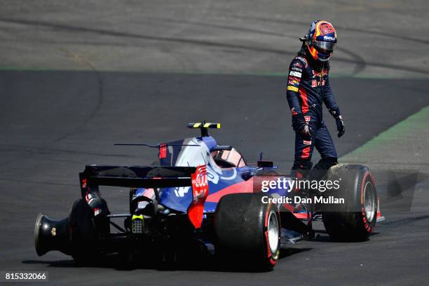 Carlos Sainz of Spain and Scuderia Toro Rosso looks at is car after retiring during the Formula One Grand Prix of Great Britain at Silverstone on...