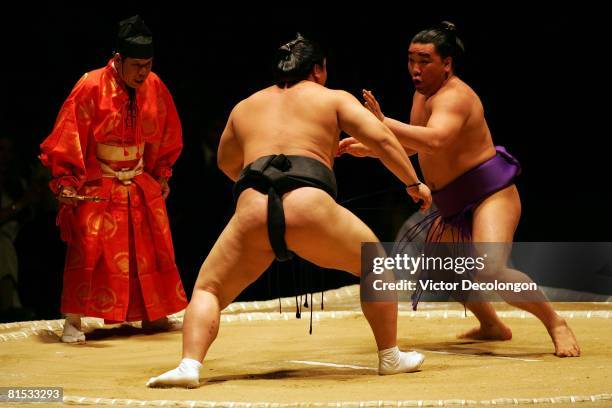 Ama, right, looks to defend himself against Hakuho in the fourth round during the 2008 Grand Sumo Tournament at the Los Angeles Memorial Sports Arena...