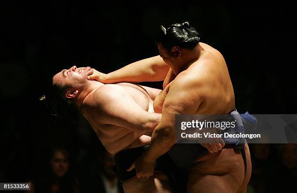 Tosanoumi pushes at the neck of Wakanoho during their second round match during the 2008 Grand Sumo Tournament at the Los Angeles Memorial Sports...