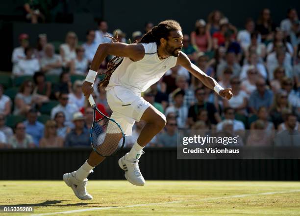 Dustin Brown of Germany in action against Andy Murray of Great Britain on day three of the Wimbledon Lawn Tennis Championships at the All England...