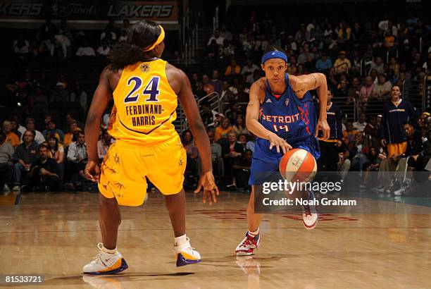 Deanna Nolan of the Detroit Shock brings the ball up the floor against Marie Ferdinand-Harris of the Los Angeles Sparks at Staples Center on June 11,...